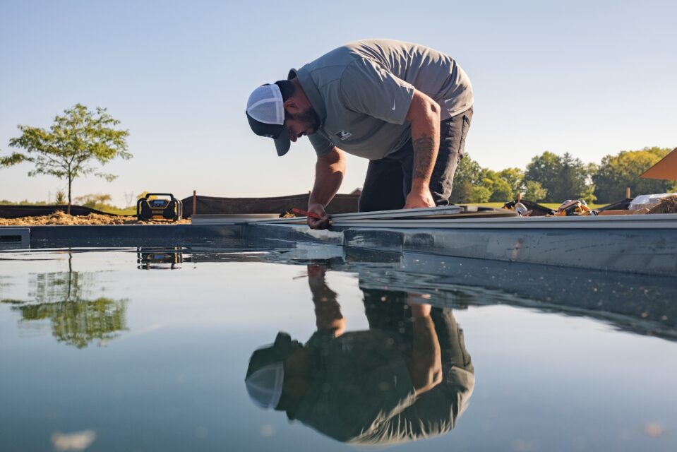 How Automatic Pool Covers Help Conserve Water During Droughts 4 3 courtesy covercare llc installer installing automatic pool cover on pool